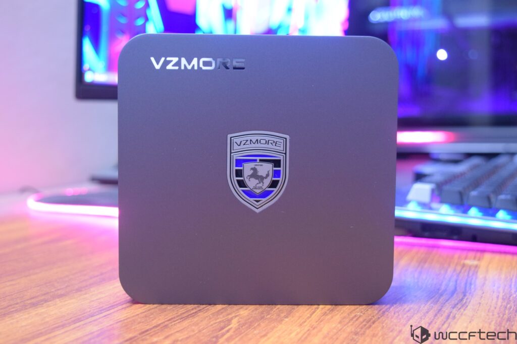A VZMORE black device with a logo and keyboard in the background.